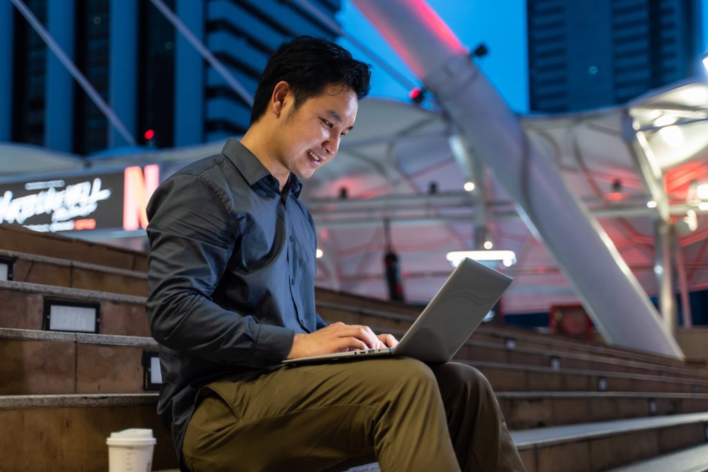 asian young businessman sitting and working outdoo 2026 01 09 07 50 12 utc